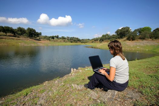 girl working in laptop in the nature