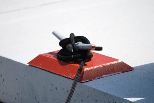 Nautical Mooring Cleat was captured on the dock as a yacht is moored to the pier.
