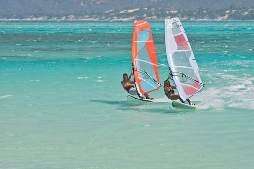 Man and women windsurfing in the lagoon