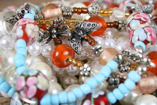 Variety of beadwork and pearl necklaces with butterflies