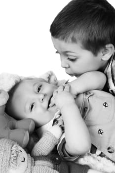 Two brothers playing amongst colorful toys on the floor