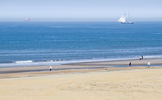 Rare phenomenon at the coast - sea with seamist or seaflame and warm sunshine on the beach