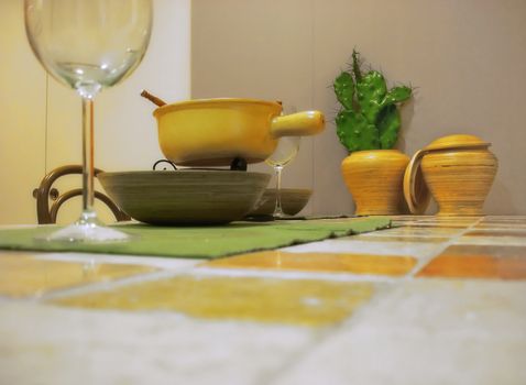 Modern kitchen table with glasses and pots on it