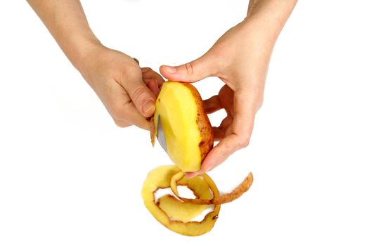 Beautiful women's hands clean potatoes peeled, isolated on a white background.