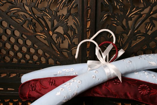 Blue and red cloth covered clothes hangers with needle work