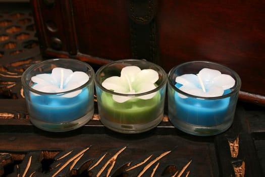Three candles on a brown wooden surface