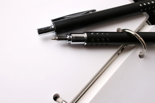 Fancy pen on a small file with white pages