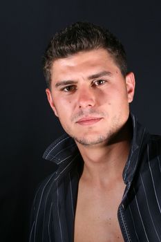 Male model in studio against a dark background