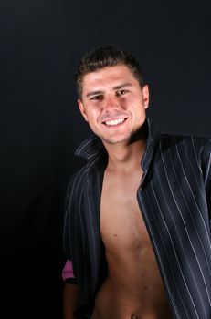 Male model in studio against black background
