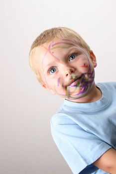 Laughing Toddler playing with colored pens making a mess