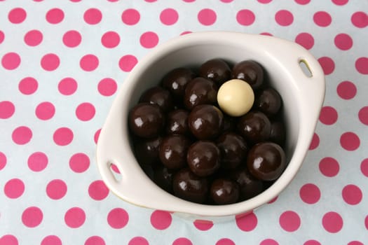 Vanilla and Dark Chocolate balls on a dotty background
