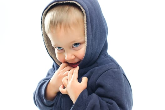 portrait of little boy in big fur hood looking at camera