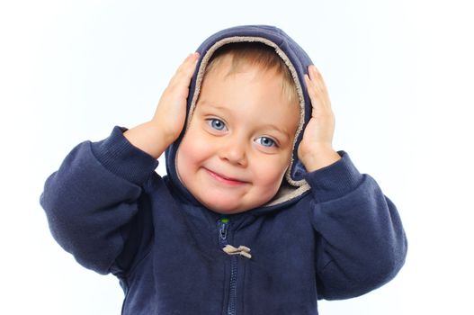 portrait of little boy in big fur hood looking at camera