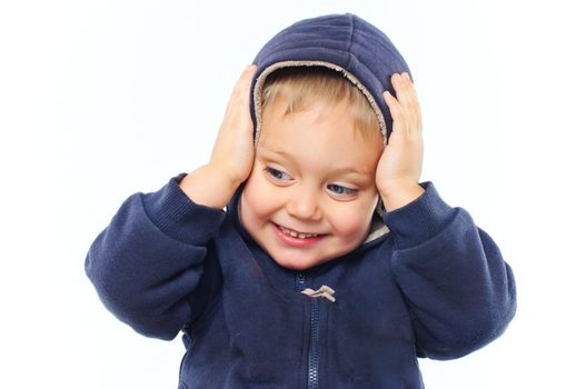 portrait of little boy in big fur hood looking at camera