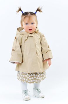 cute baby girl in nude stylish outfit in studio