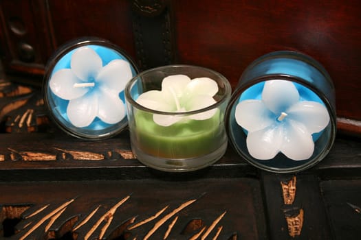 Three candles on a brown wooden surface