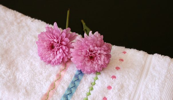 Plush pink flowers on an embroided hand towel
