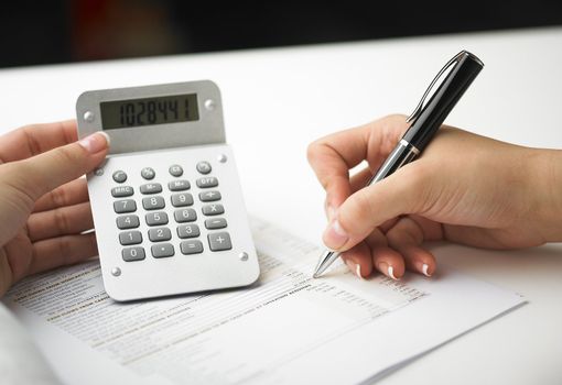 Market Analyze - pen and calculator on papers