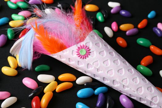 Brightly colored feather confetti in a cone