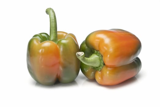 Red and green peppers isolated over a white background.