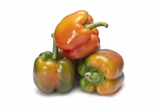 Red and green peppers isolated over a white background.