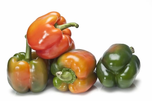 Red and green peppers isolated over a white background.