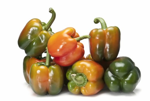 Red and green peppers isolated over a white background.