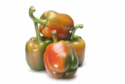 Red and green peppers isolated over a white background.