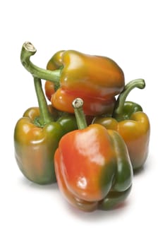 Red and green peppers isolated over a white background.