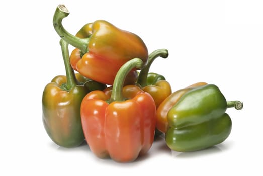 Red and green peppers isolated over a white background.