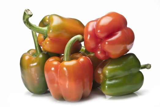 Red and green peppers isolated over a white background.