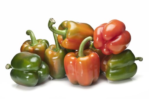 Red and green peppers isolated over a white background.