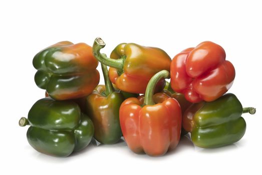 Red and green peppers isolated over a white background.