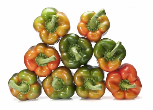 Red and green peppers isolated over a white background.