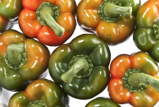 Red and green peppers isolated over a white background.