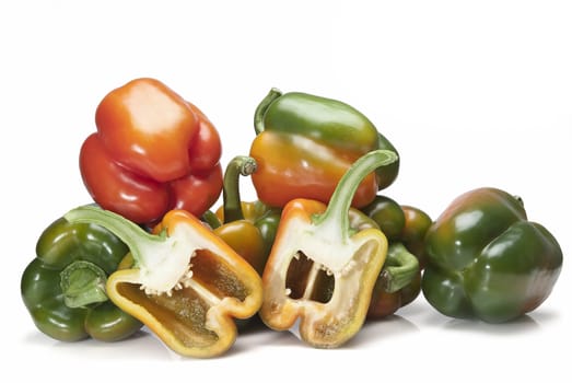 Red and green peppers isolated over a white background.