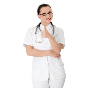 Young nurse or female doctor gesturing OK, isolated on white background