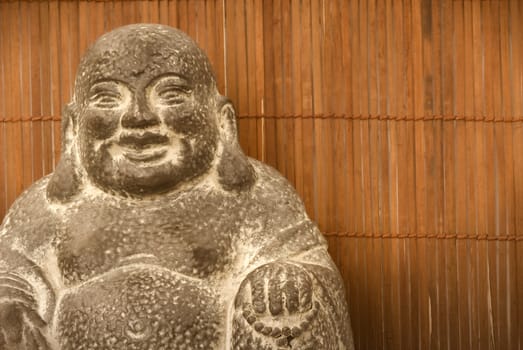 Buddha figure on a background of bamboo 