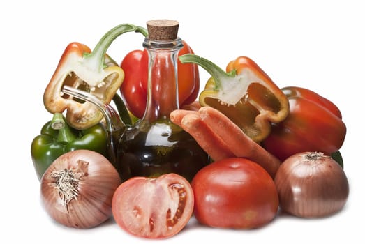 Olive oil and some vegetables like tomatoes, peppers and onions to make gazpacho isolated over a white background.