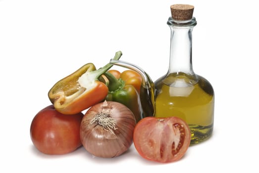 Olive oil and some vegetables like tomatoes, peppers and onions to make gazpacho isolated over a white background.