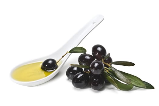 Black olives and a spoonful of olive oil isolated over a white background.