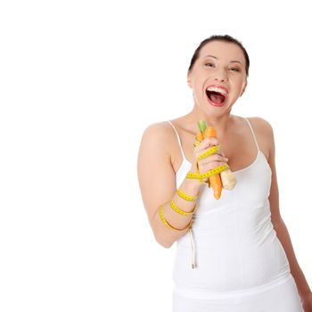 Wom's holding vegetables and measuring tape, isolated on white. Diet concept