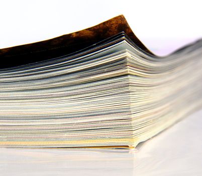 Close-up of magazine's edge on white background