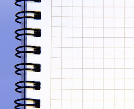 notebook sheet on blue background. Close up.