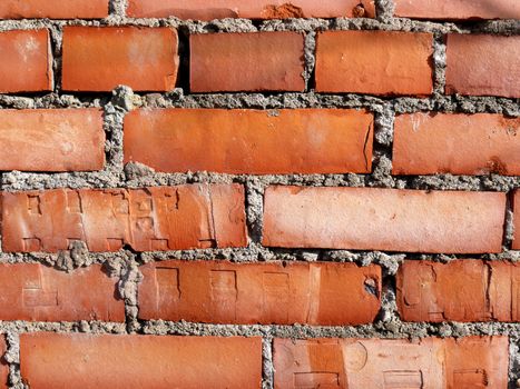 Old brick wall with bright orange bricks
