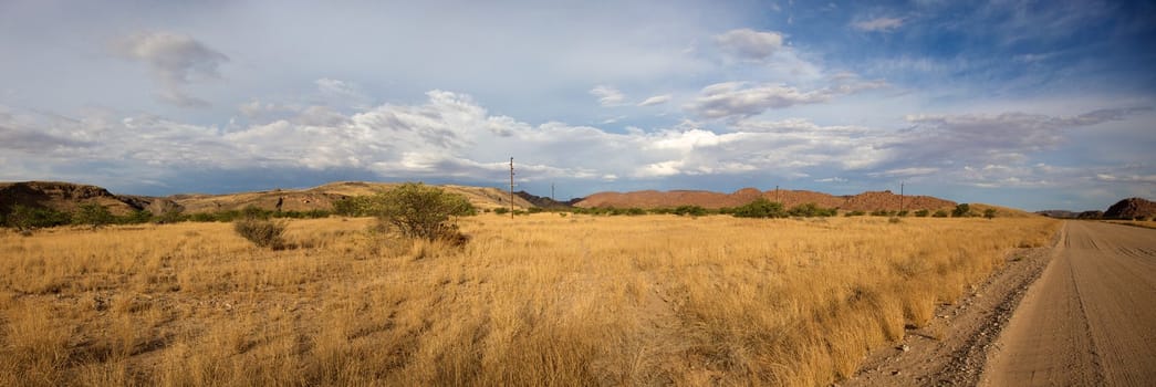 Panoramic view of the Brandberg gravel road in Namibia.