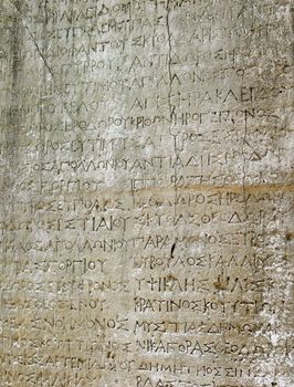 Ancient greek text carved on a stone slate