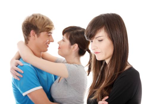 Sad brunette girl jealousy about her friend. Isolated on white background.