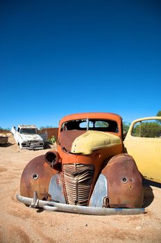 Old car on the road in Namibia with a blue sky