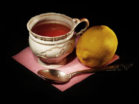 A cup of tea with the lemon and a spoon